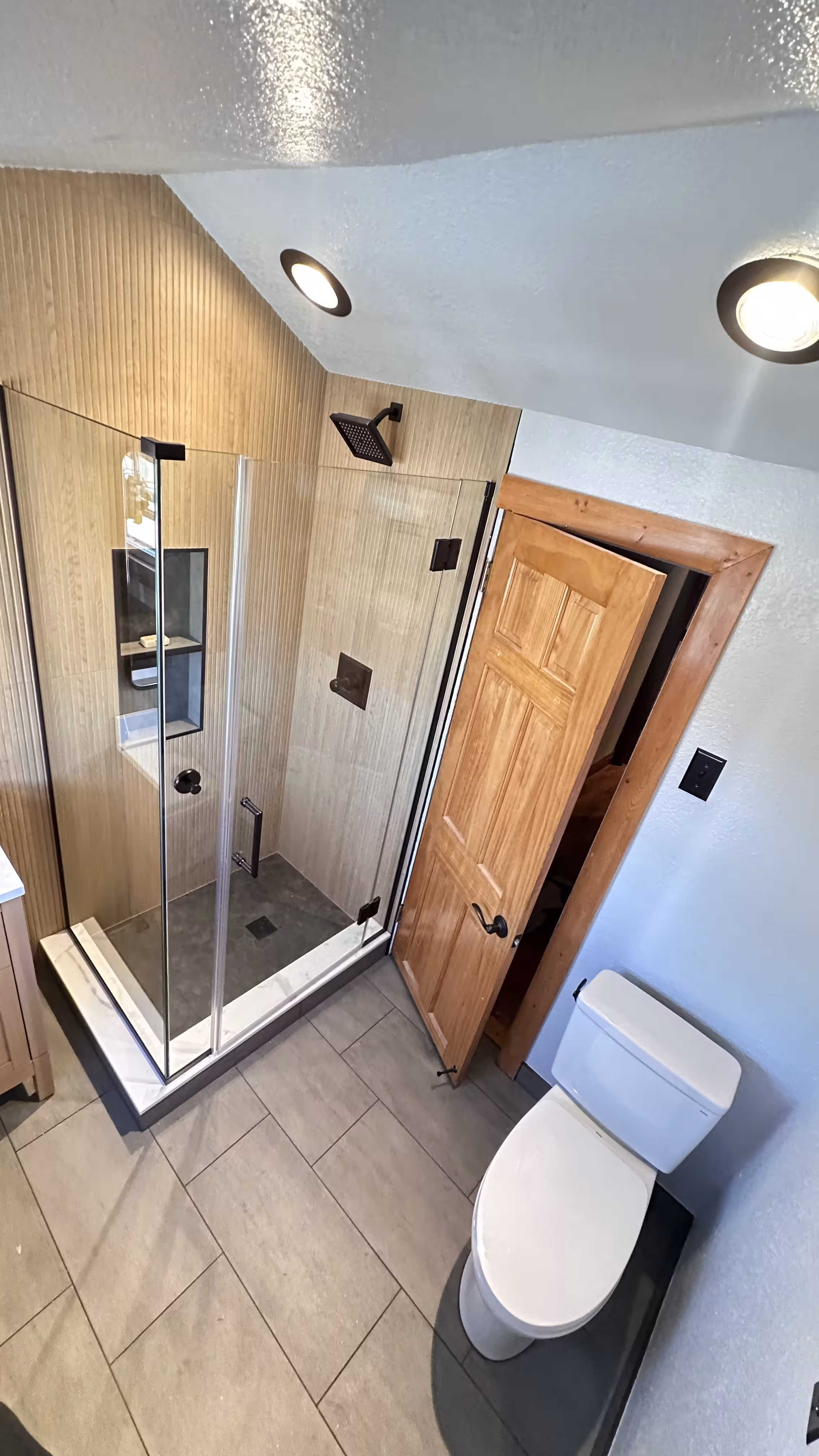 Finished custom shower remodel with frameless glass door in Denver