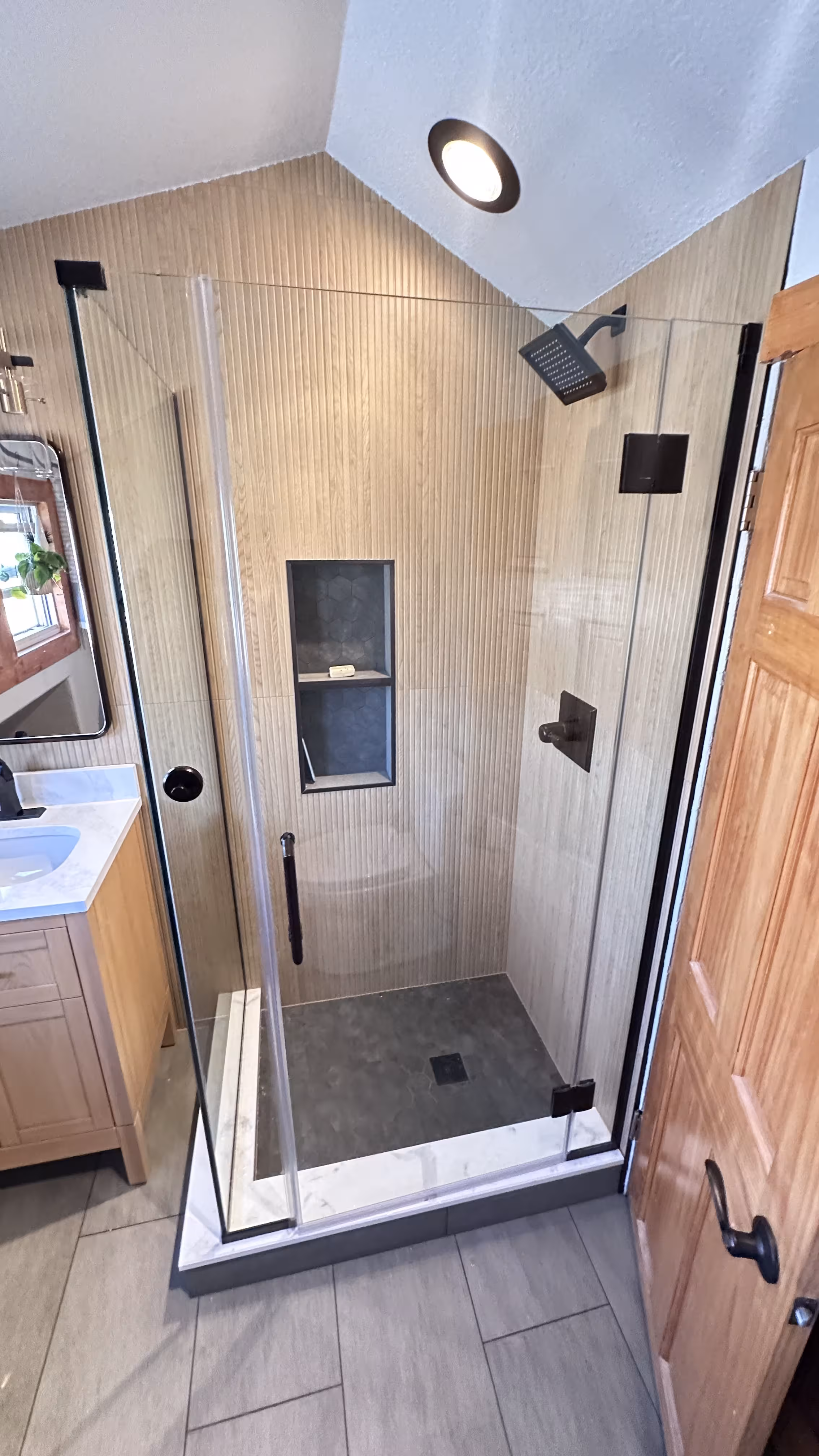 Custom tile shower remodel in Denver with 24x48 inch porcelain
