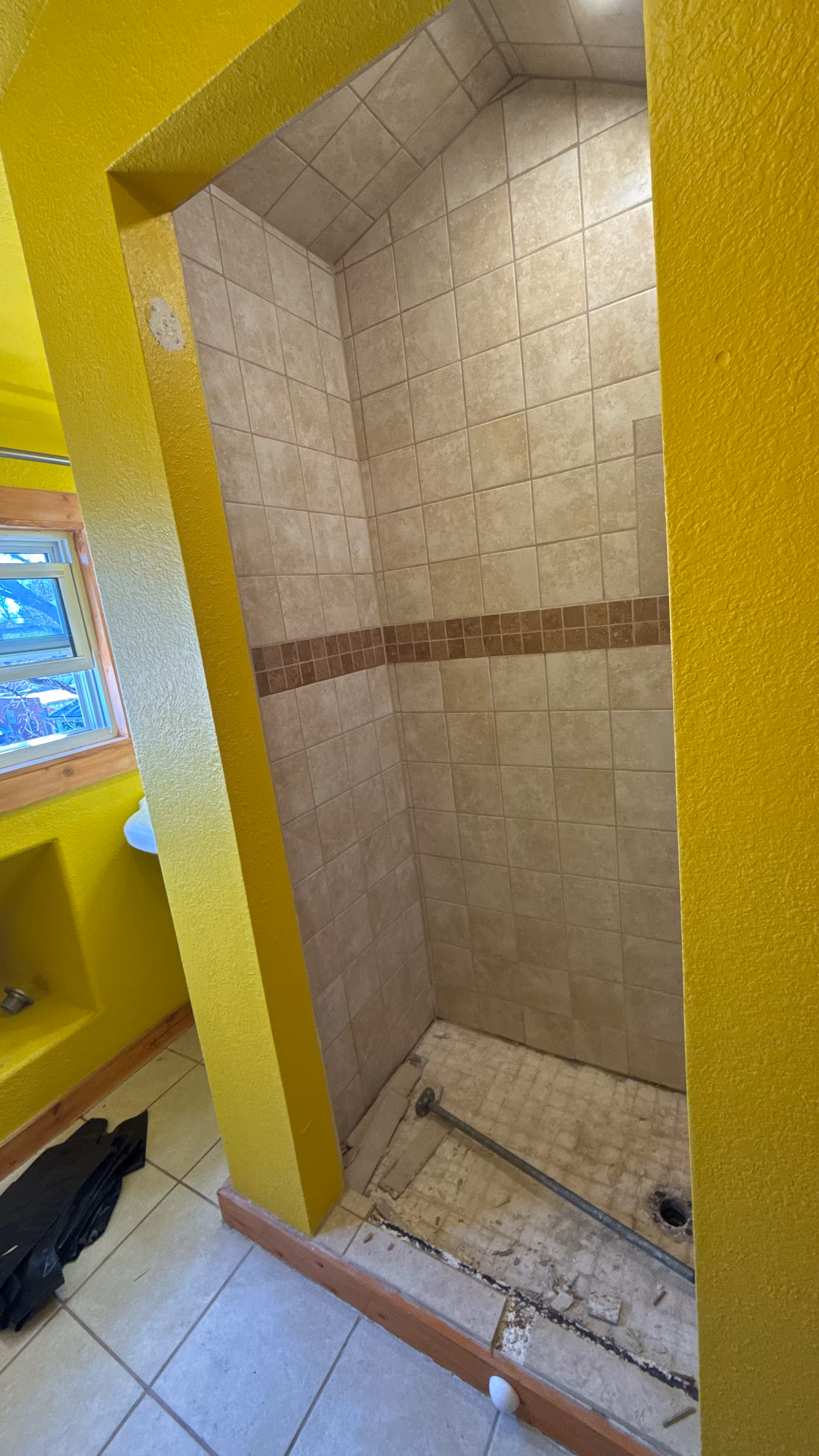 Framing and wall work during a custom shower remodel in Denver