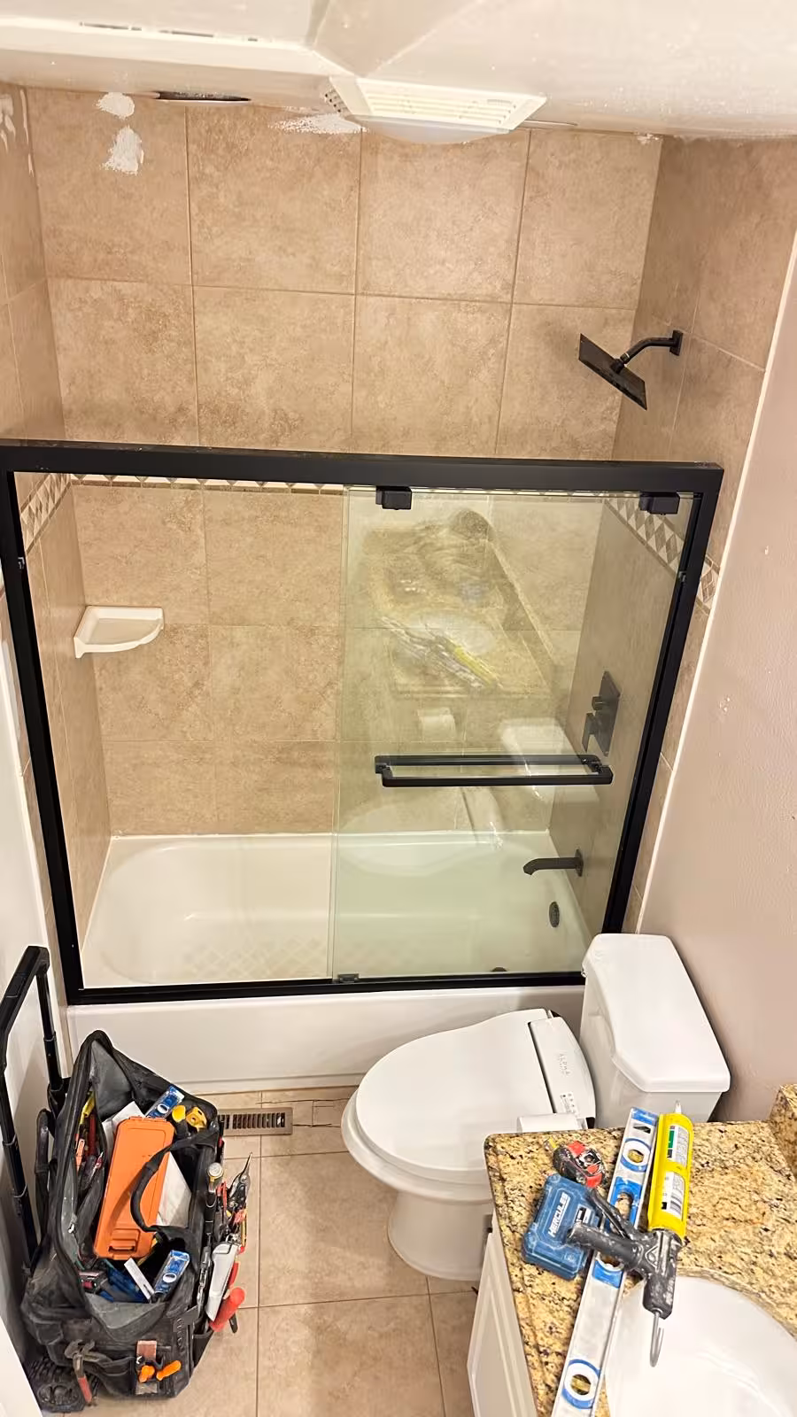 Before photo of old tub shower and toilet in Aurora bathroom before tub-to-shower conversion