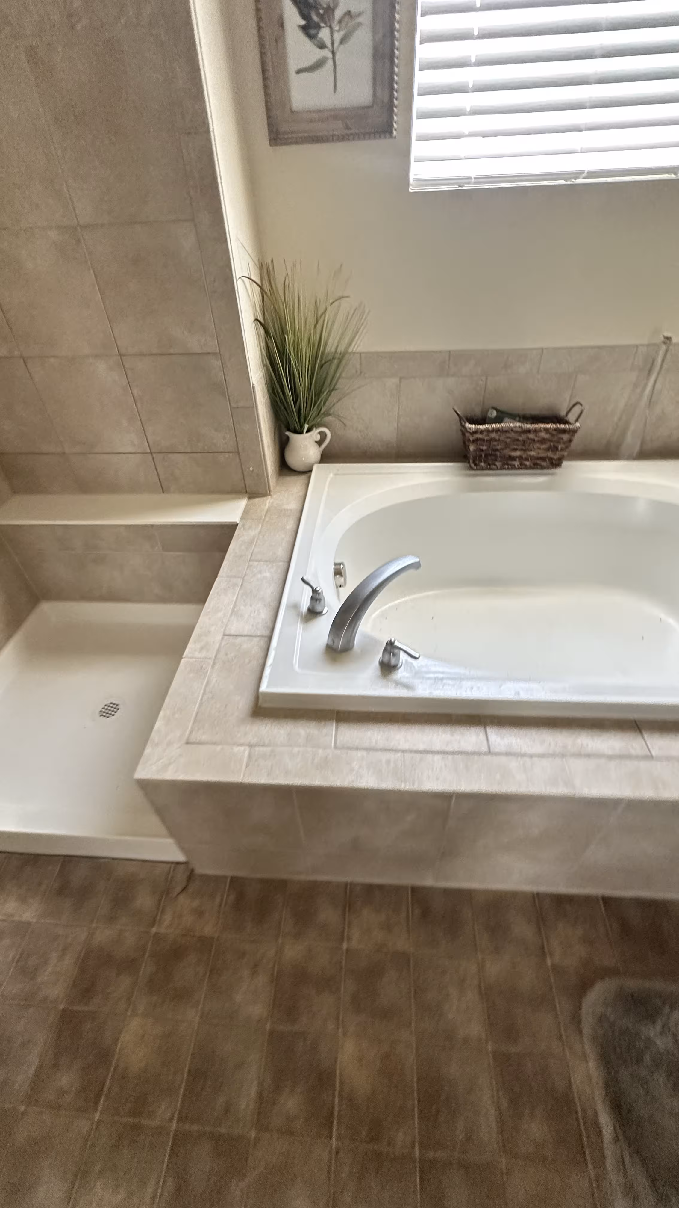 Close-up of the chrome tub faucet and tiled deck on the rebuilt soaking tub in Aurora, CO