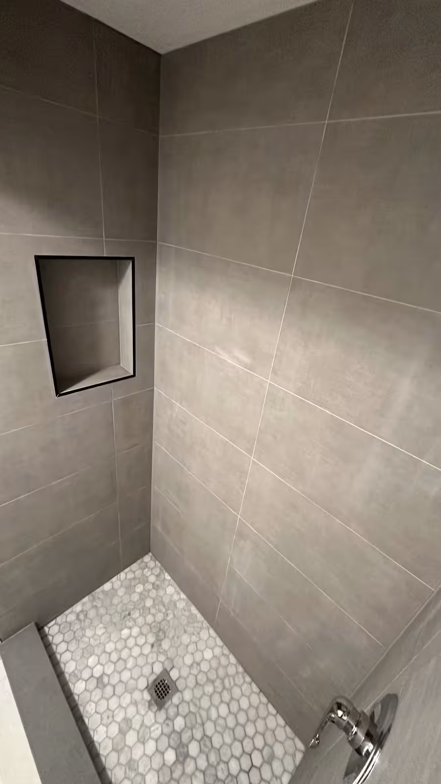 Finished tiled shower niche with 12x24 wall tile in Arvada shower leak repair and rebuild