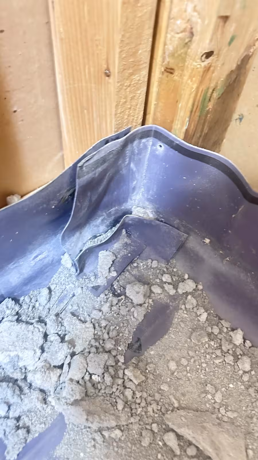 Damaged shower pan corner with loose mortar in Denver