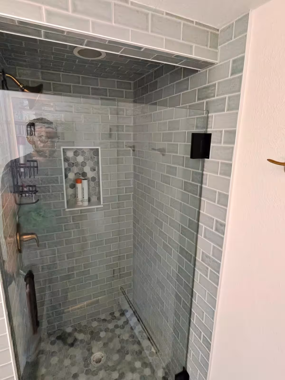 Completed shower with hexagon floor tile and built-in niche after liner repair Denver