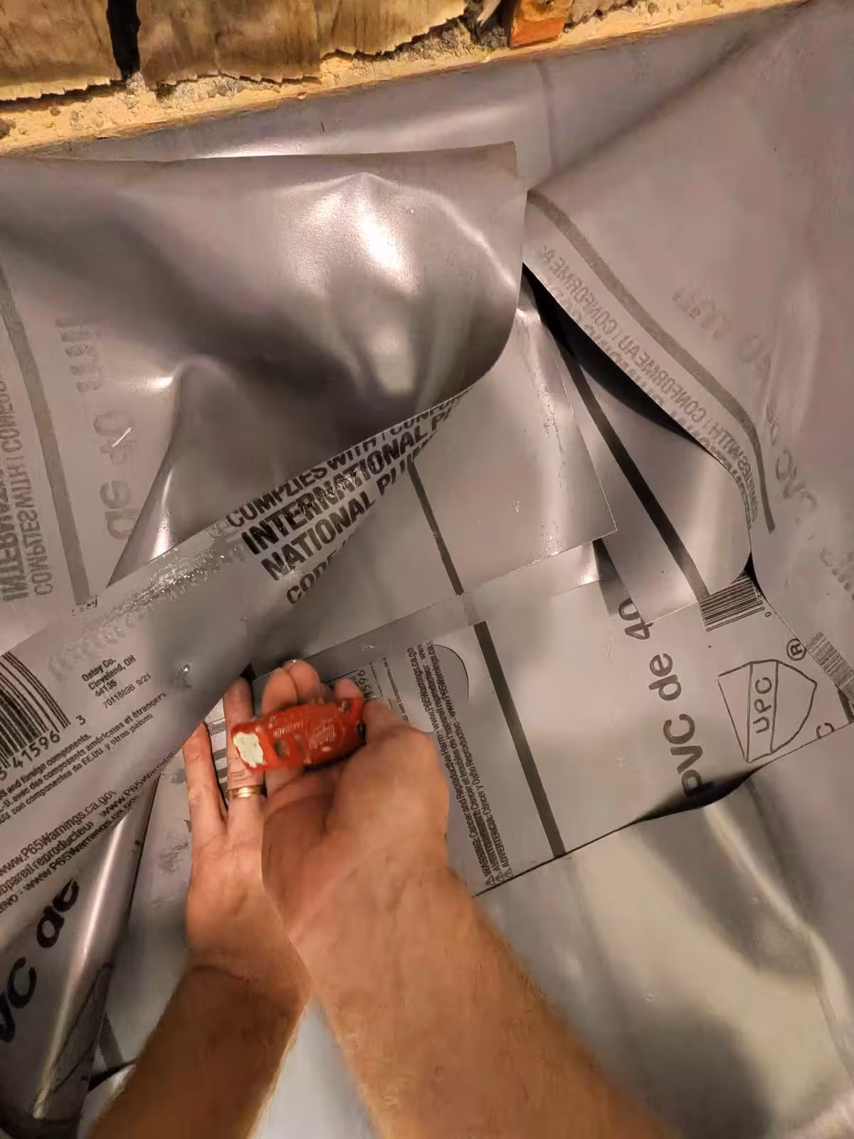 PVC shower pan liner preparation with folded corners Denver