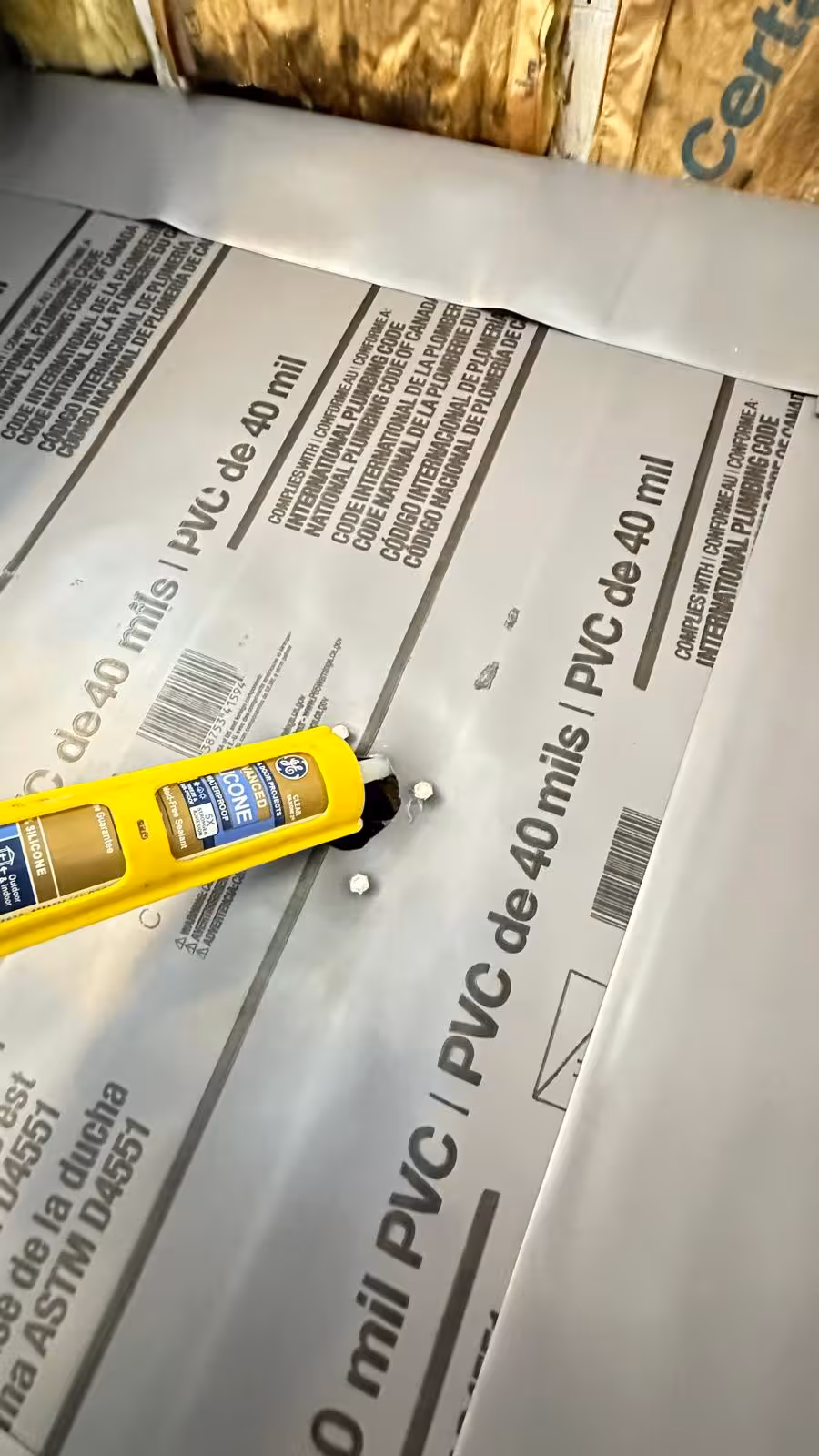 New PVC shower liner and adhesive installation during custom shower pan repair in DTC