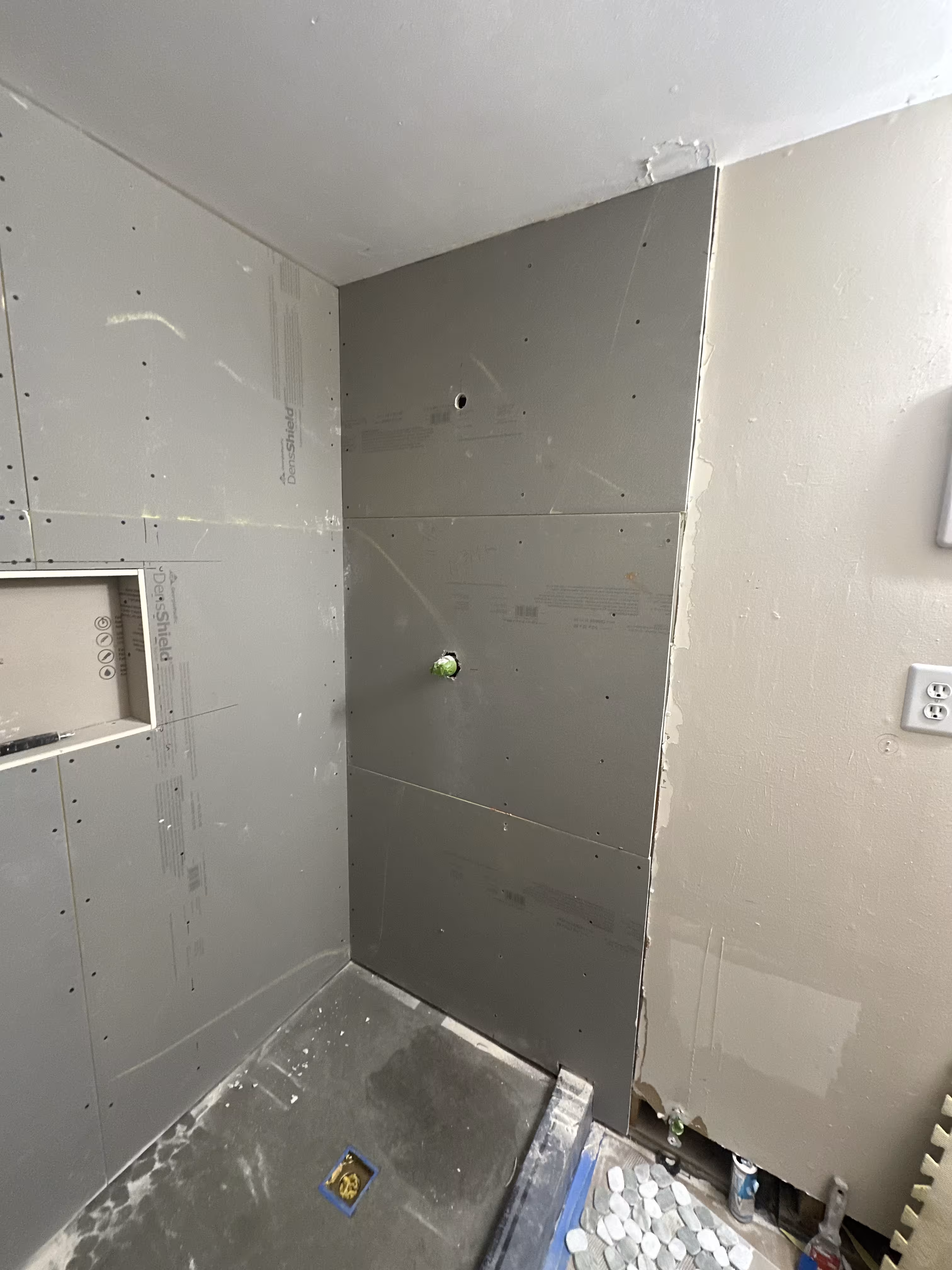 Waterproof cement backer board installed with the soap niche opening cut