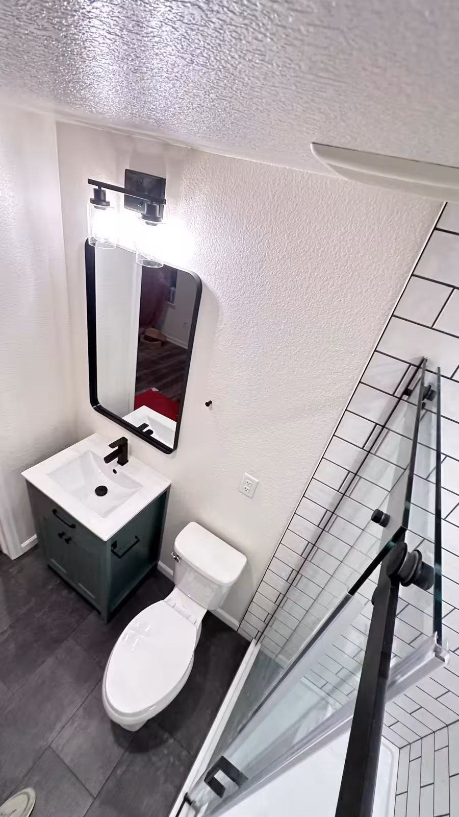 Overhead view of compact bathroom remodel with shower addition
