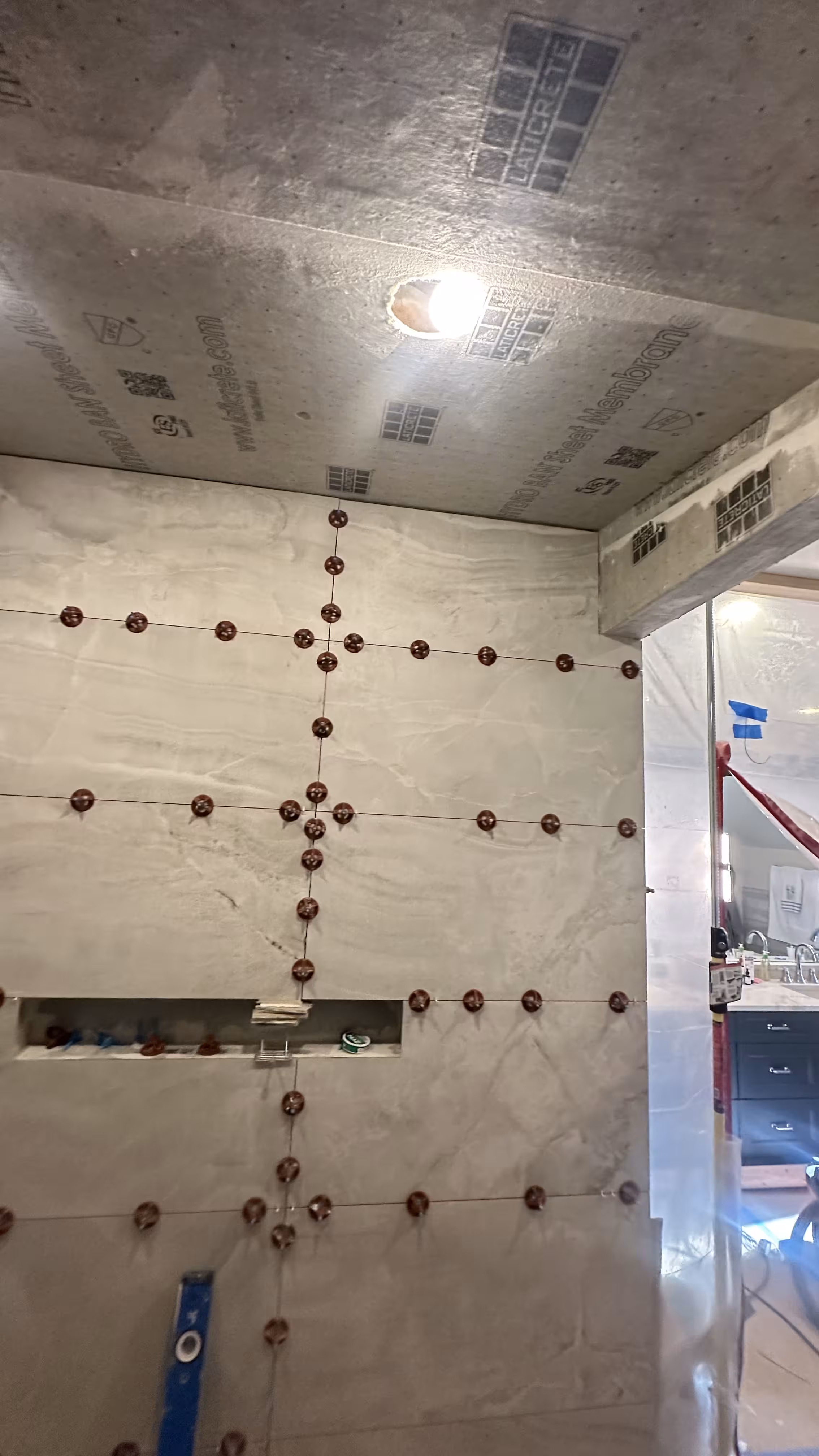 Hydro Ban waterproofing membrane installed on a steam shower ceiling with tile layout dots marked before tiling in Denver, CO