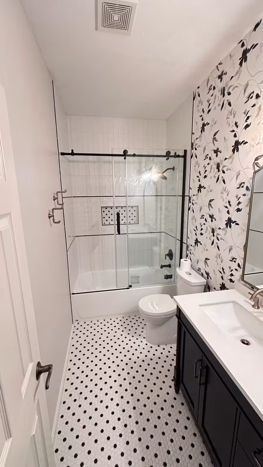 Black and white mosaic bathroom floor close-up in Aurora designer bathroom project