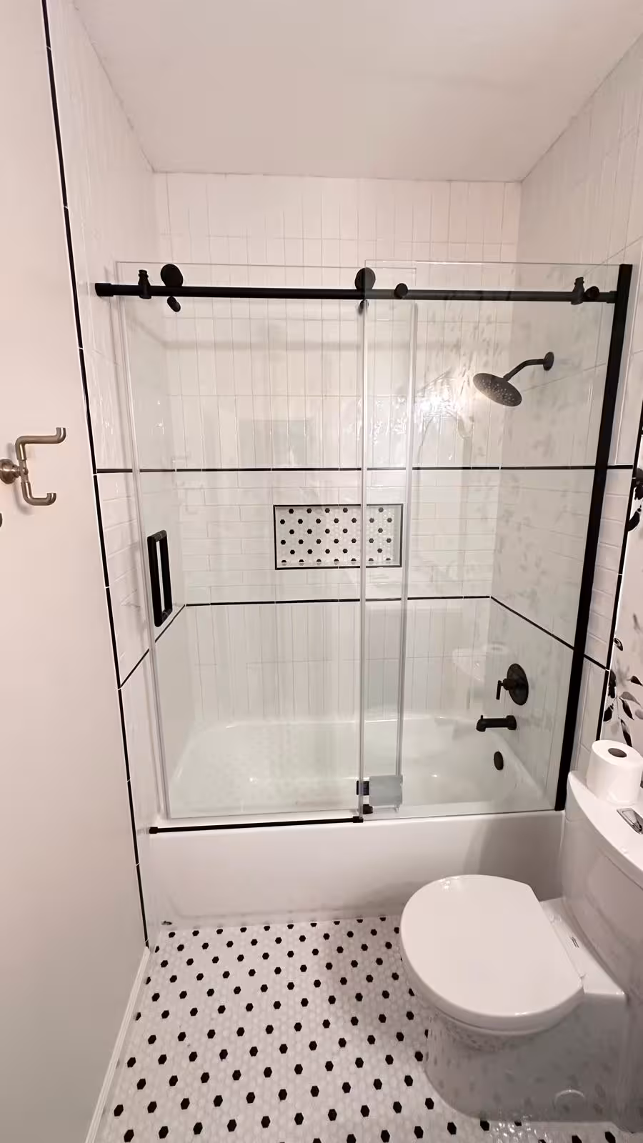 Recessed wall niche with mosaic accent and black trim in Aurora tiled tub surround