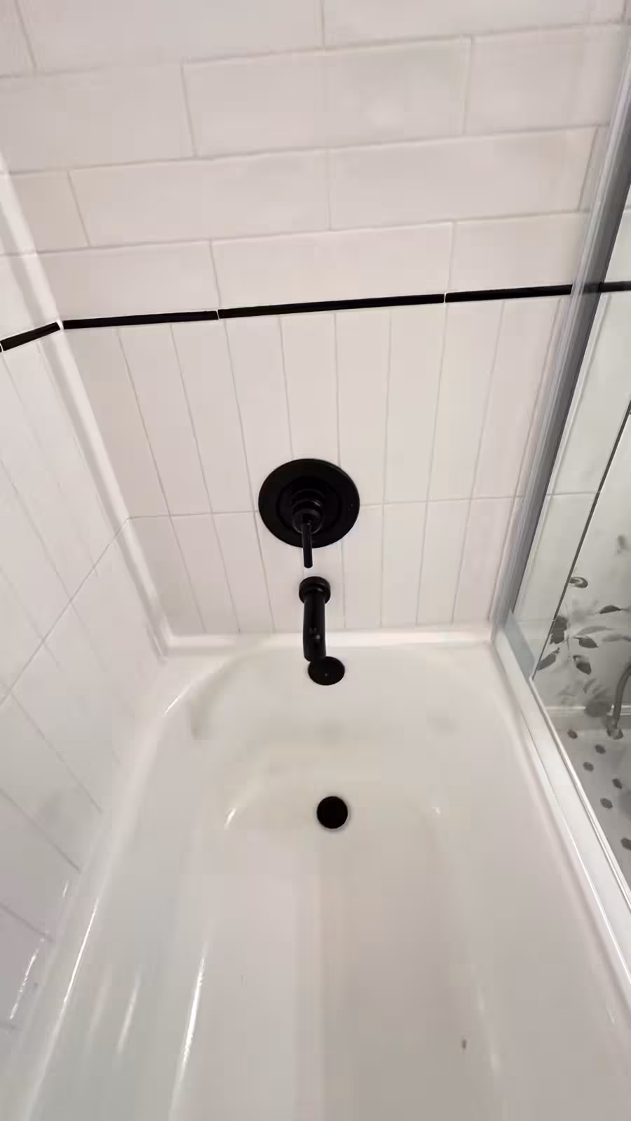 Professional tile work showing subway tile with black accent inserts Arvada bathroom renovation