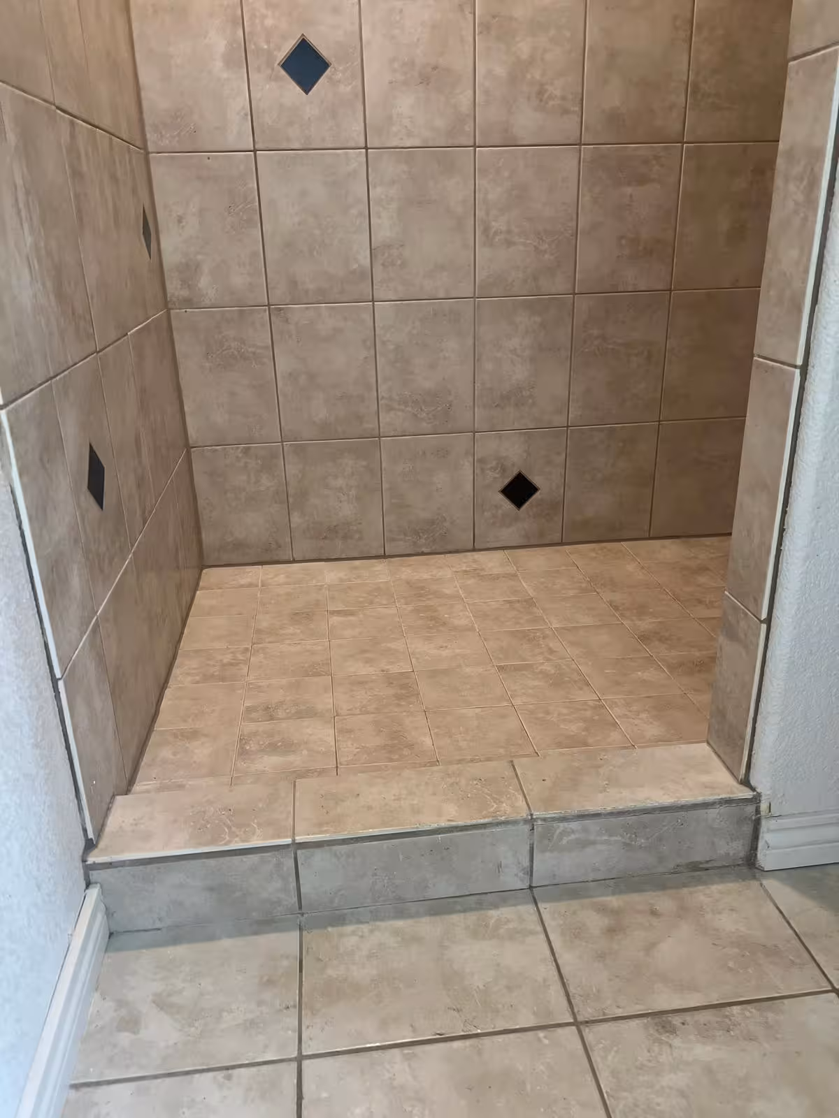 Shower entrance and threshold before repair showing existing tile installation Elizabeth Colorado