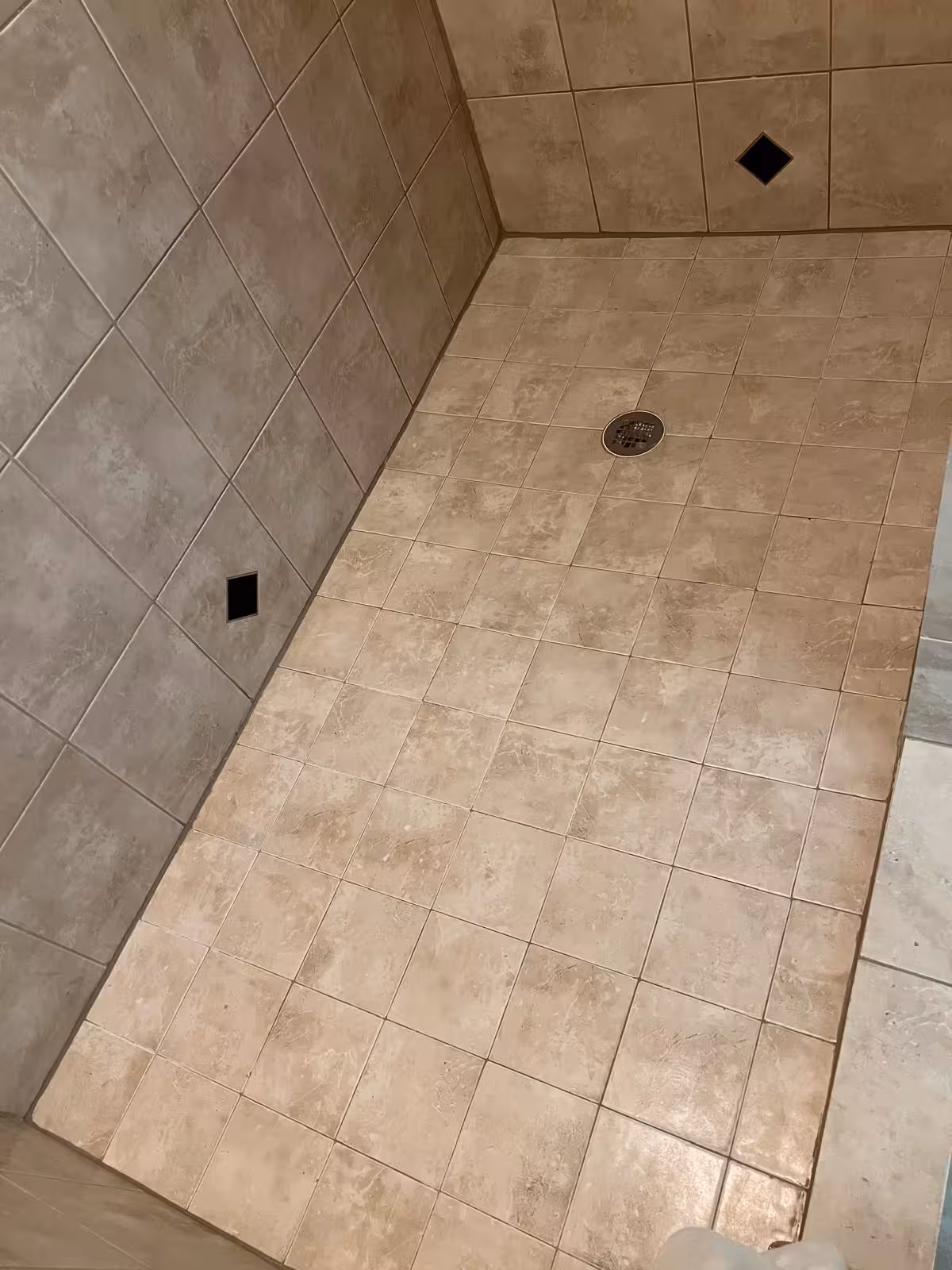 Original shower floor tile before demolition concealing water damage beneath Elizabeth Colorado