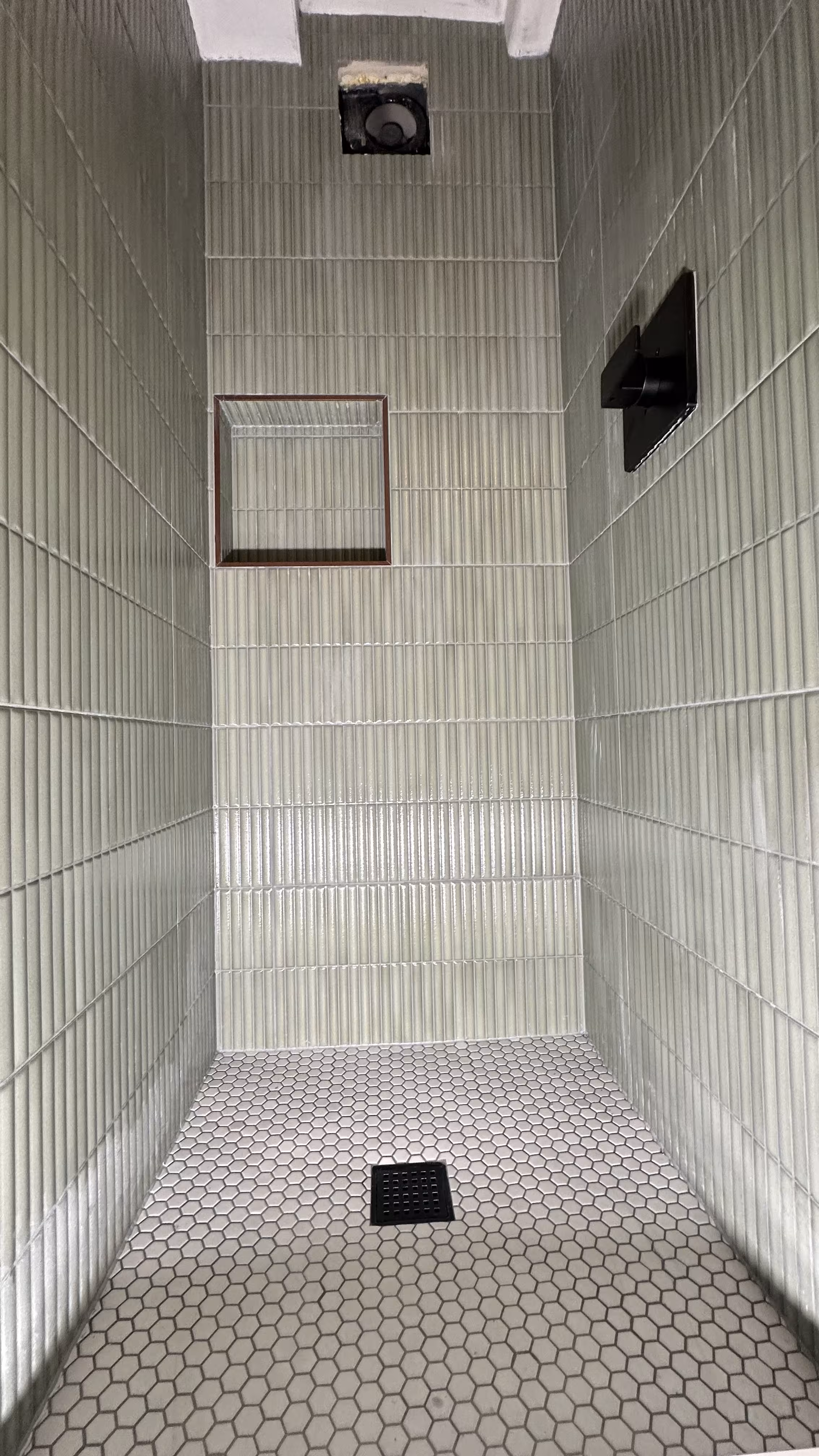 Full-height view of the green fluted tile shower wall with recessed niche in Arvada