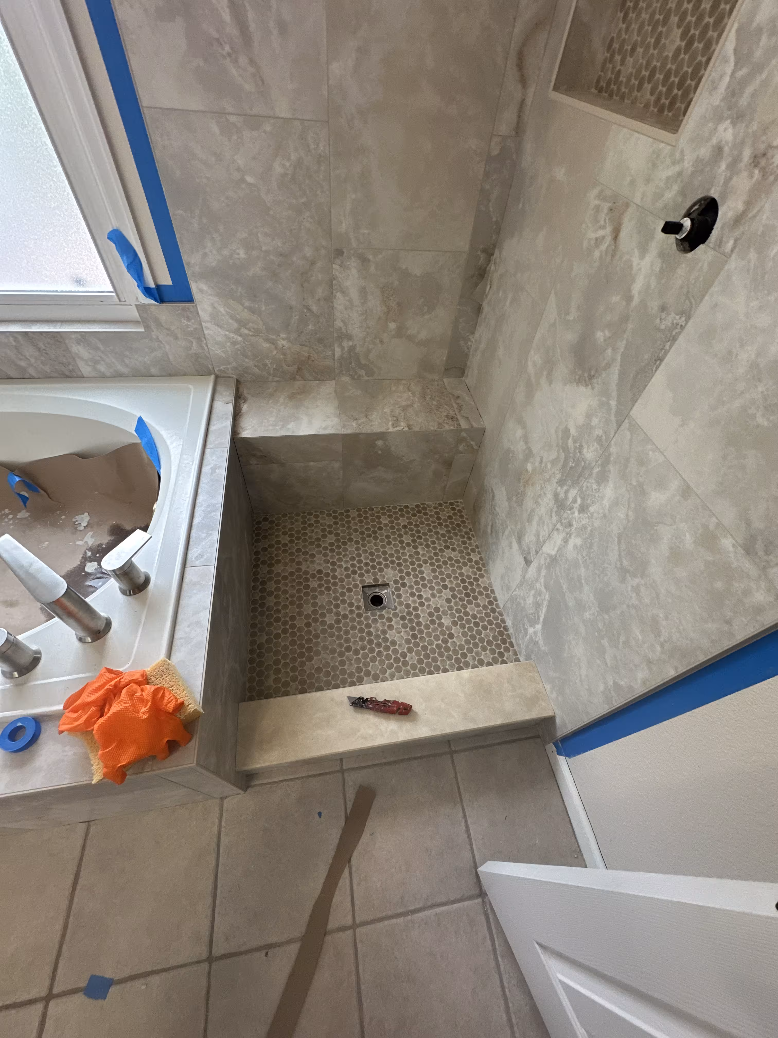 Wide view of the finished master bathroom showing the soaking tub and walk-in shower together in Highlands Ranch