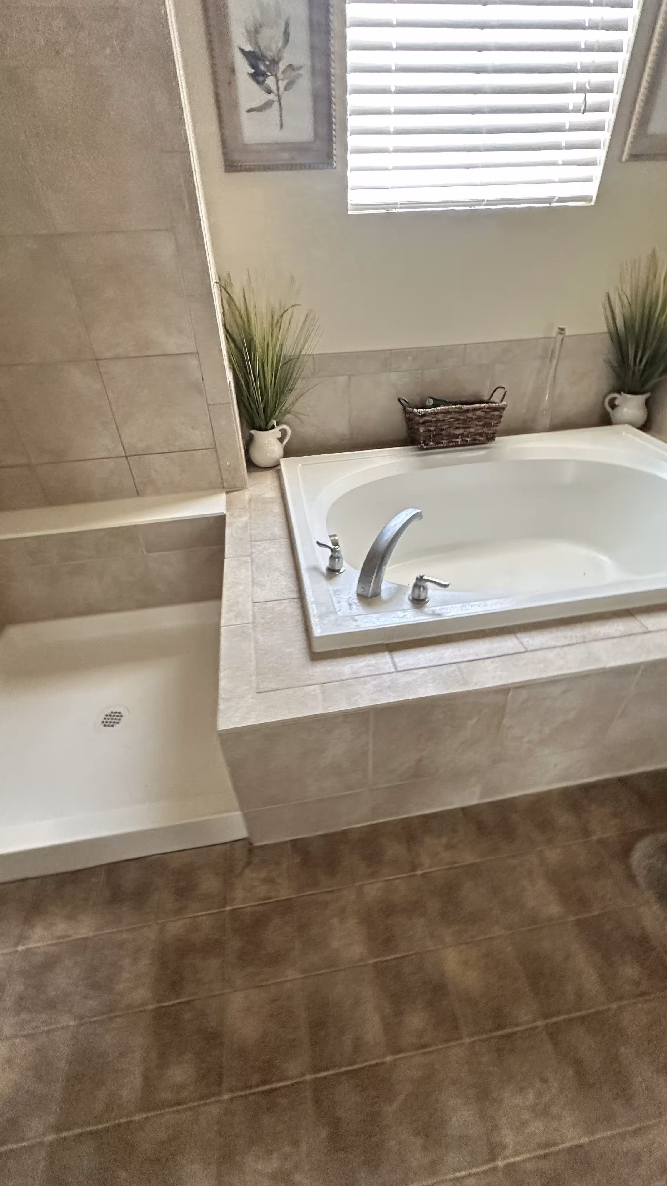 Rebuilt shower and soaking tub beneath a window with fresh tile surround in Aurora