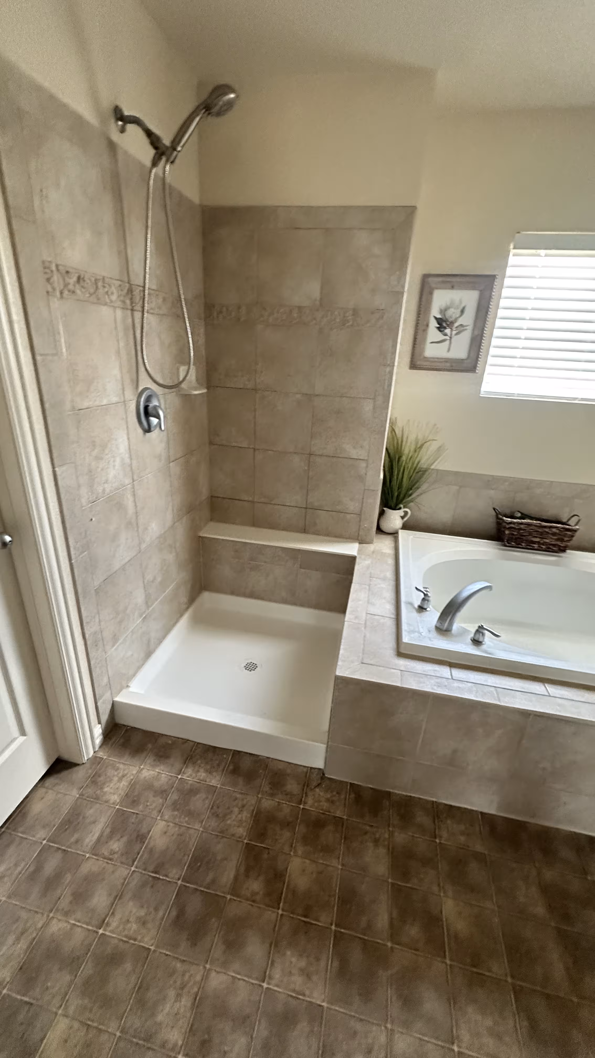 Finished tile shower and soaking tub side by side after a full bathroom rebuild following water leak repair in Aurora, CO