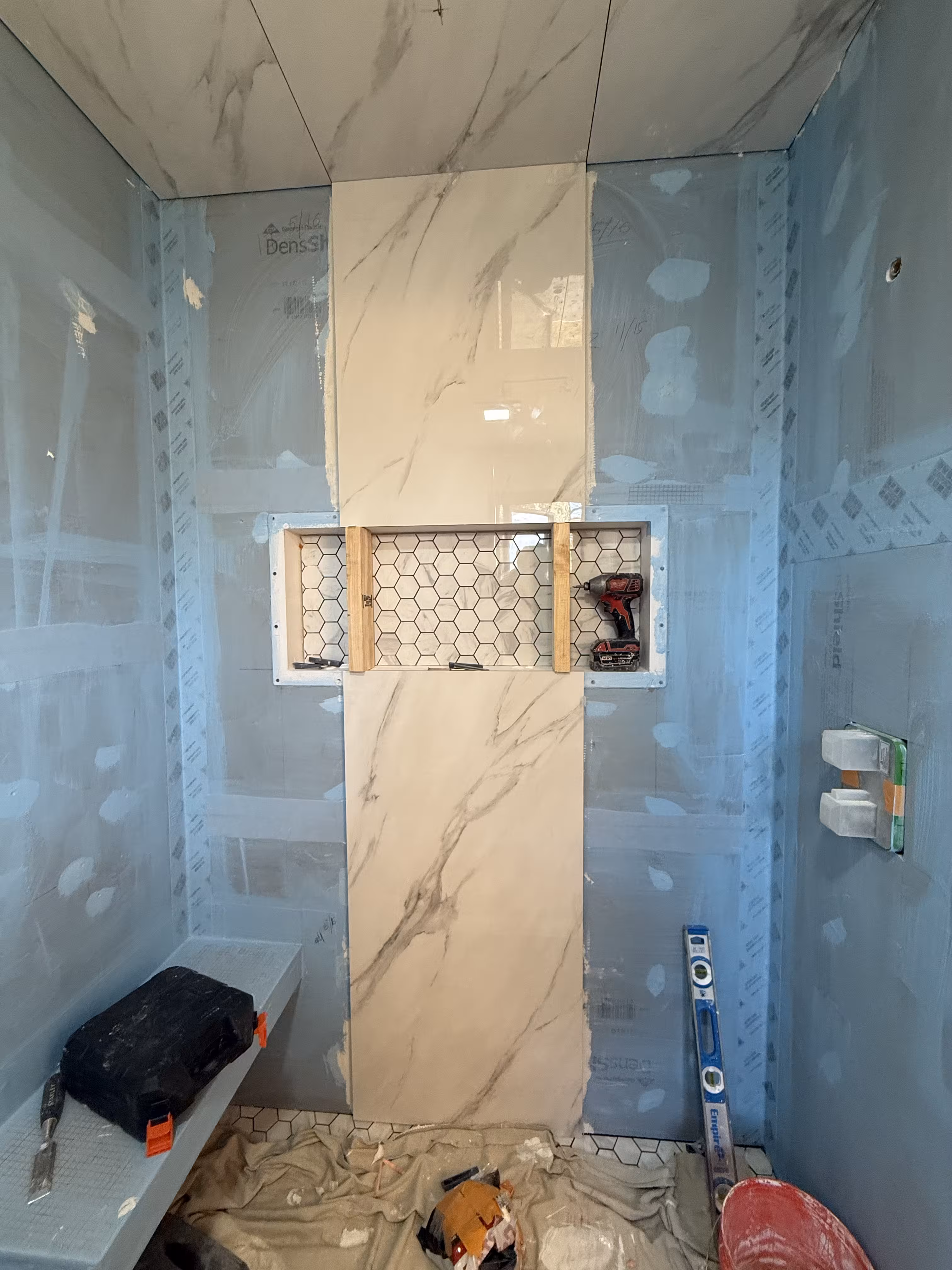 Large centered shower niche under construction with waterproofed walls