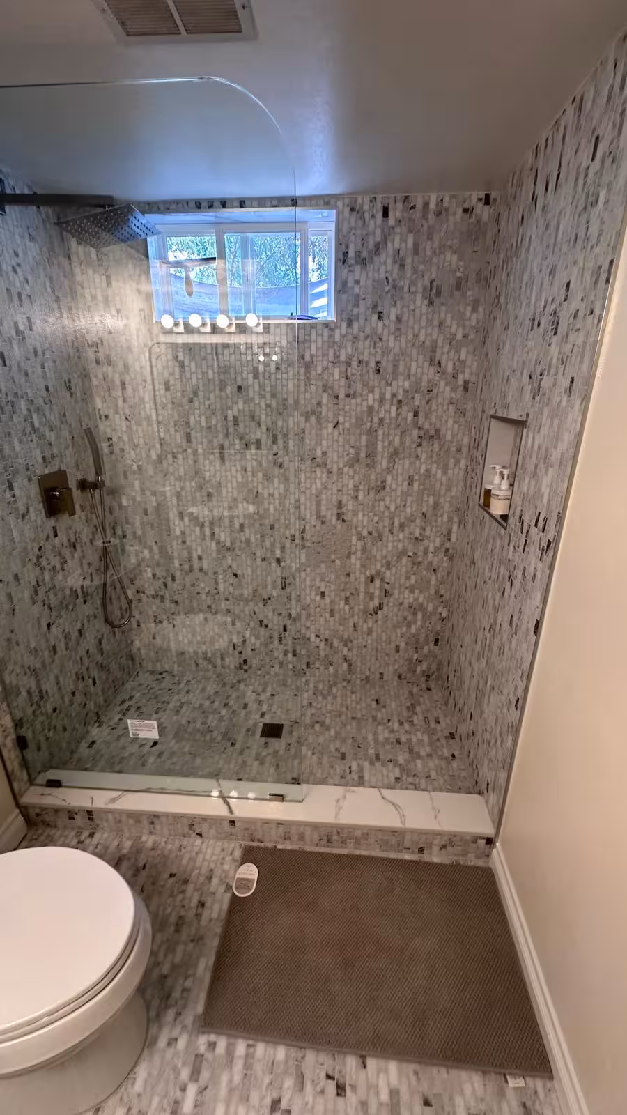Completed modern shower with rainfall showerhead and marble mosaic Littleton