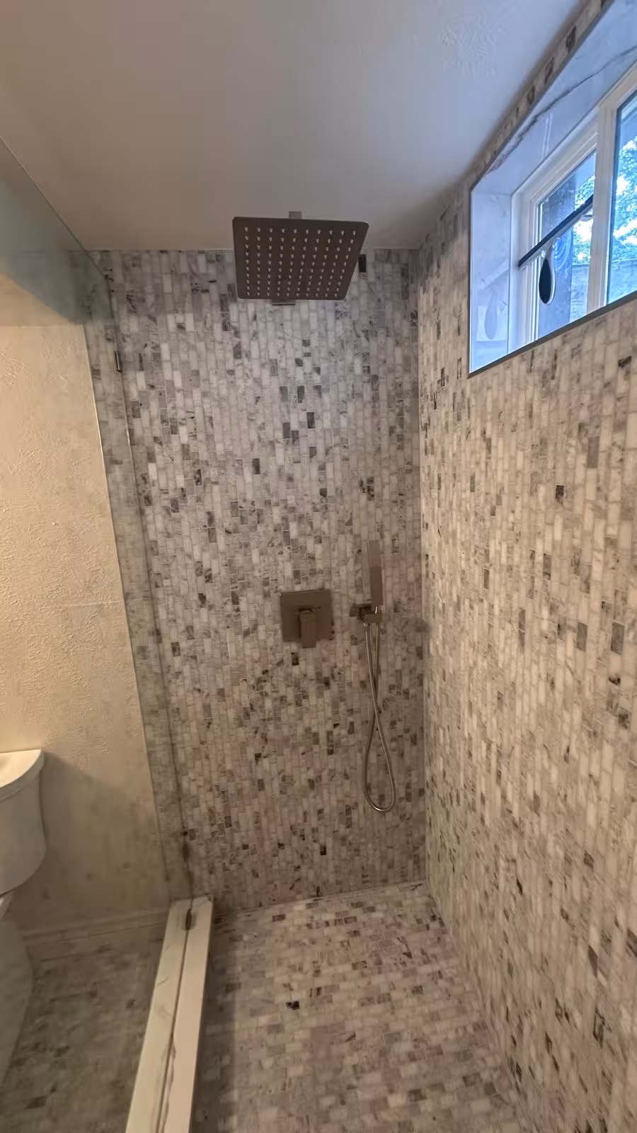 Modern basement walk-in shower with marble mosaic tile Littleton renovation