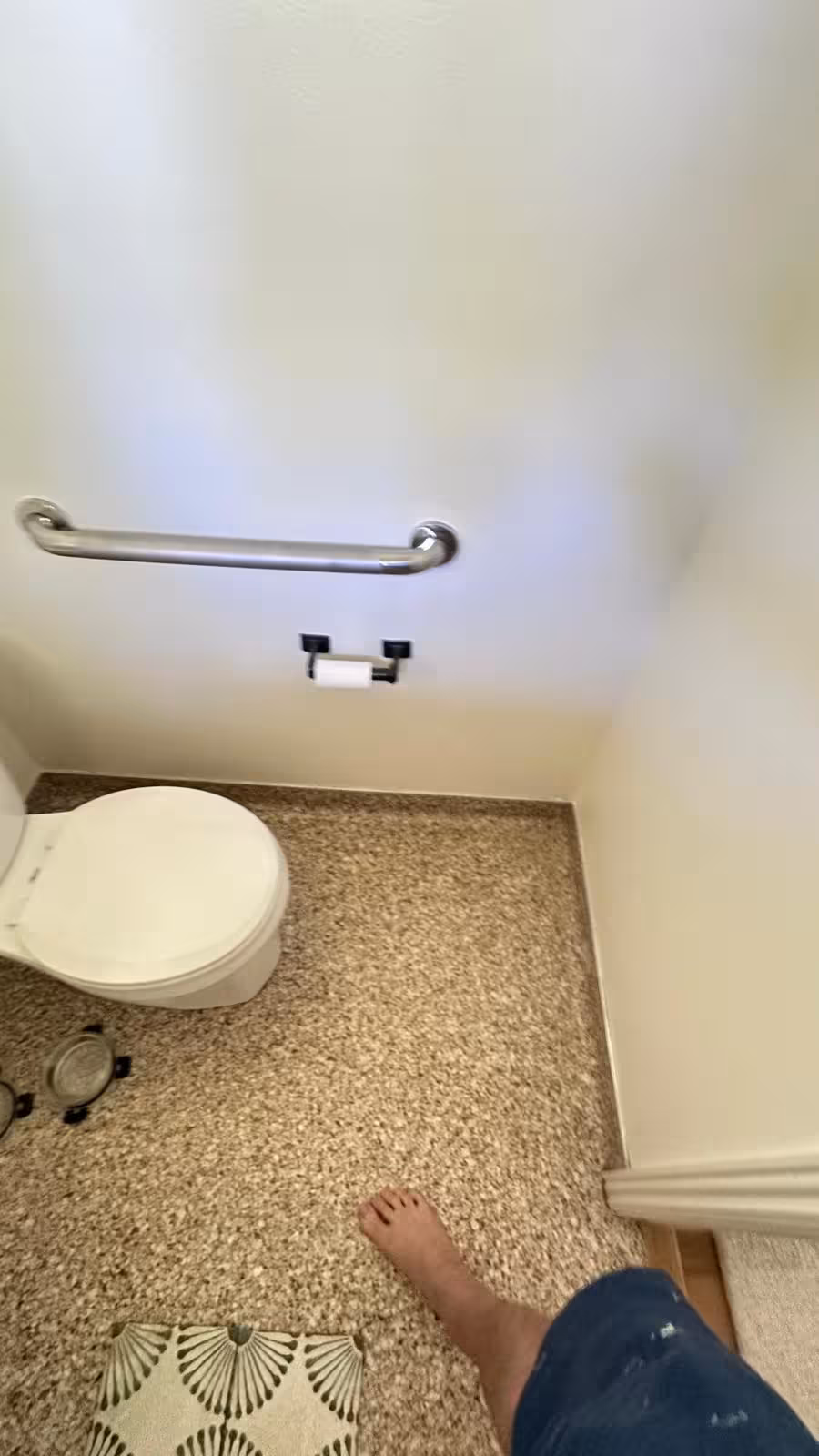 Old basement bathroom with toilet and granite floor before renovation Littleton