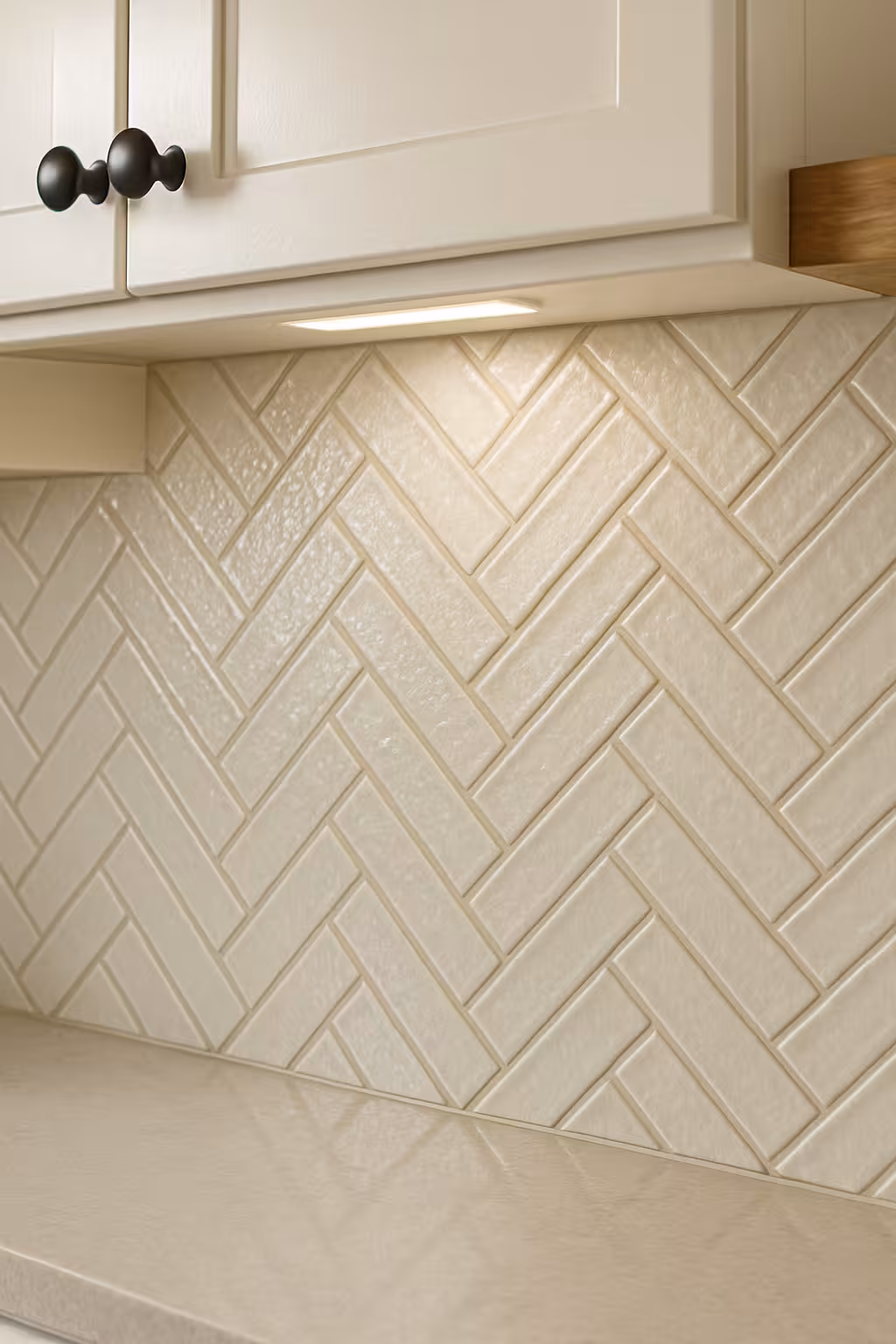 Elegant cream herringbone tile backsplash in a Parker, CO kitchen.