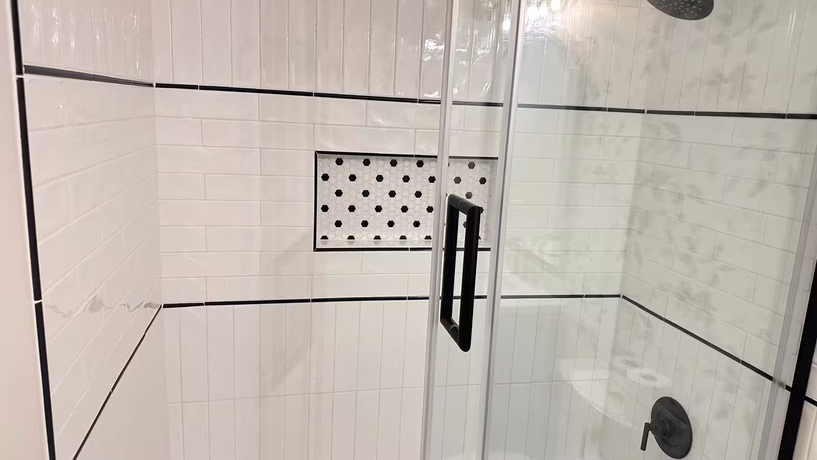 Bathroom tile installation in progress showing white subway tile wall pattern Arvada Colorado remodel