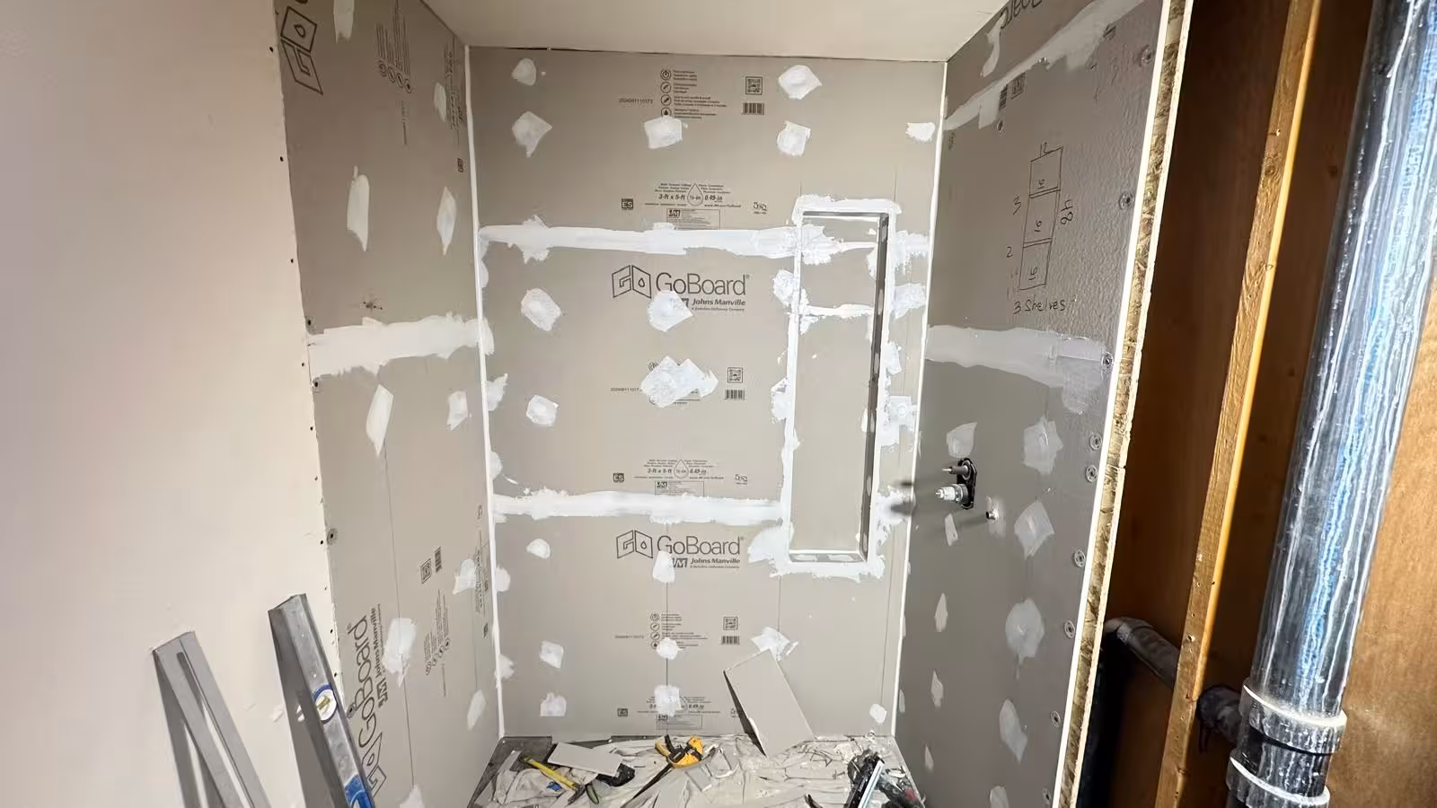 GoBoard waterproofing installation during Littleton bathroom renovation with shower pan preparation