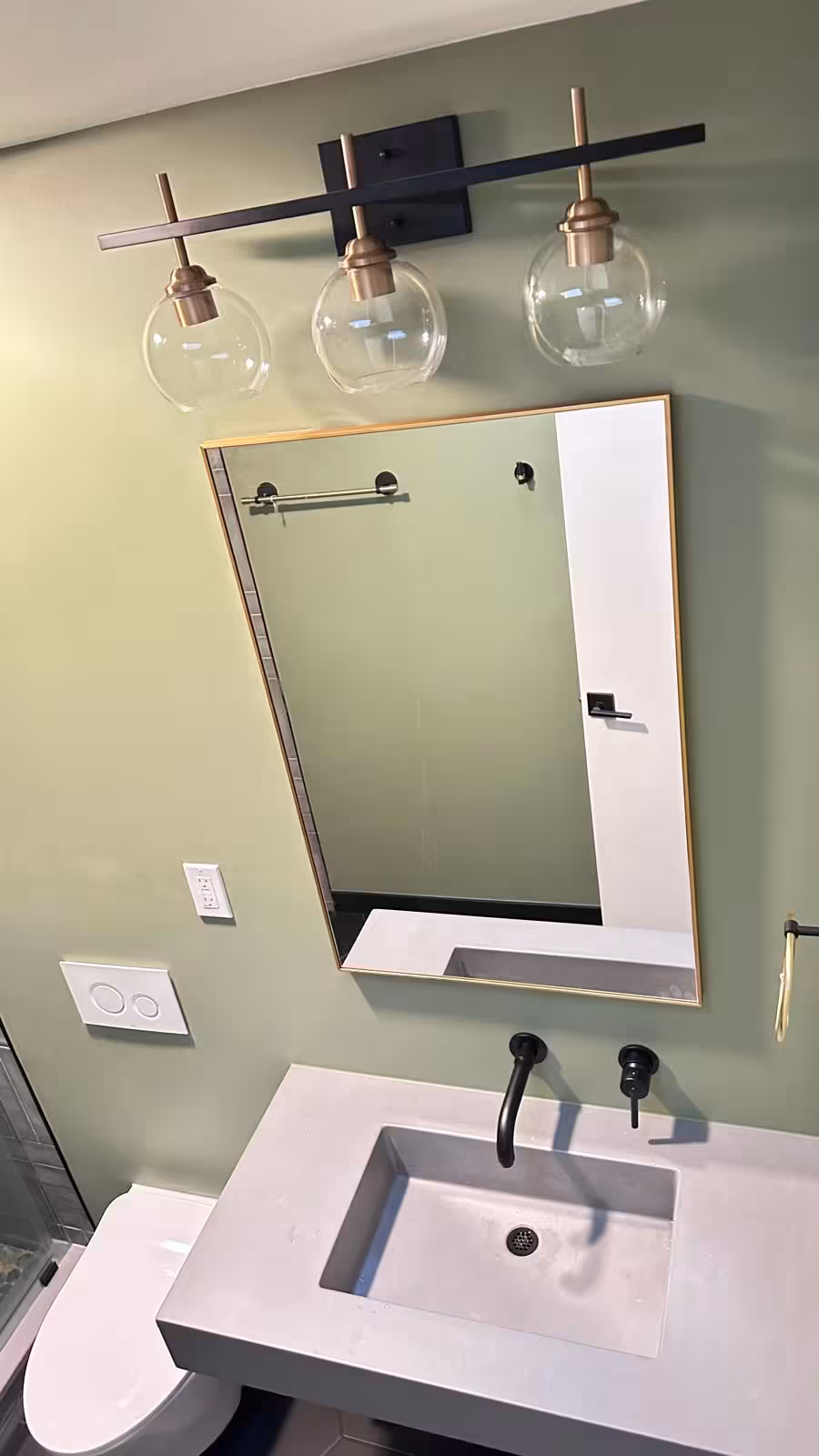 Contemporary bathroom vanity area with medicine cabinet mirror and updated lighting fixtures