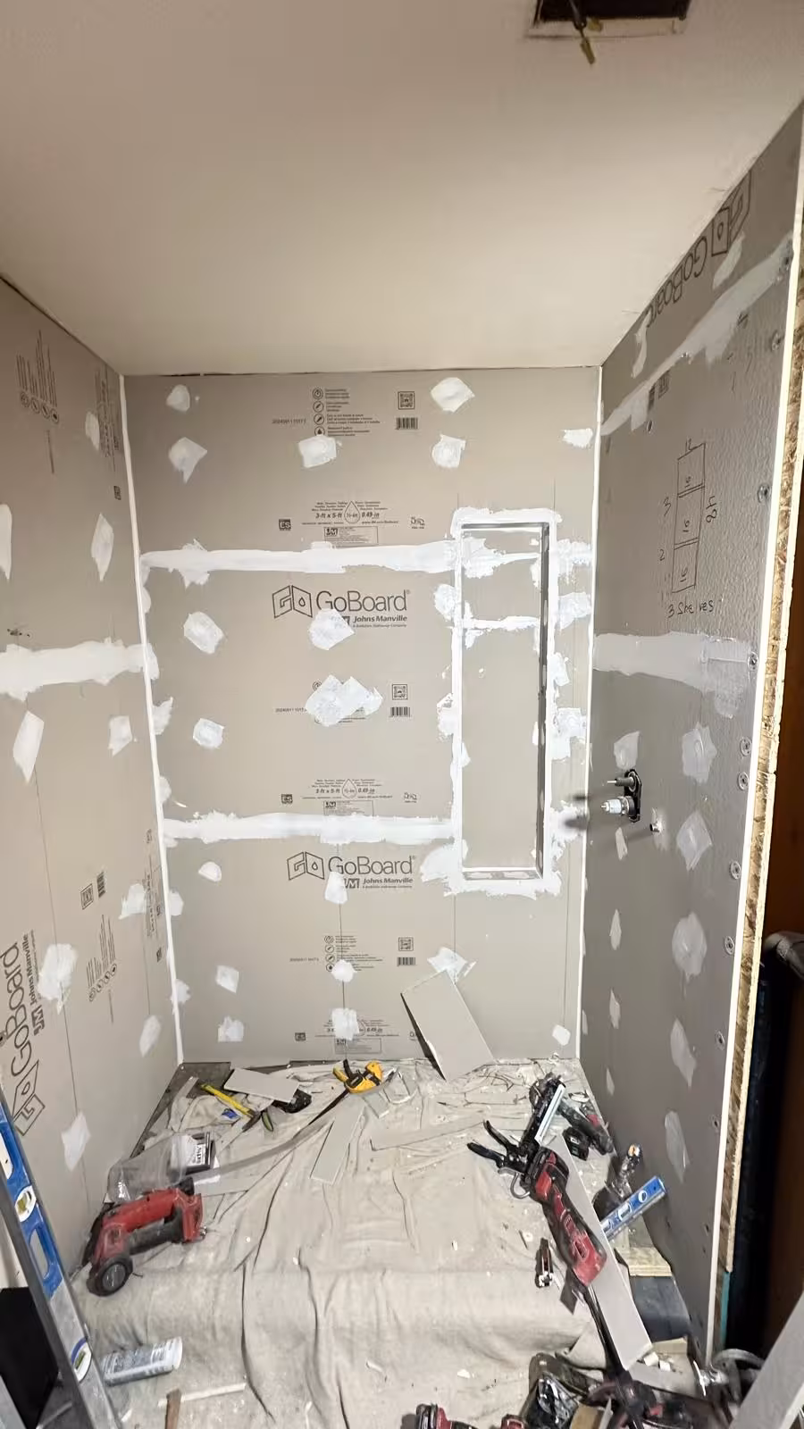 Bathroom remodel construction phase showing wall framing and plumbing rough-in for wall-hung toilet Littleton Colorado