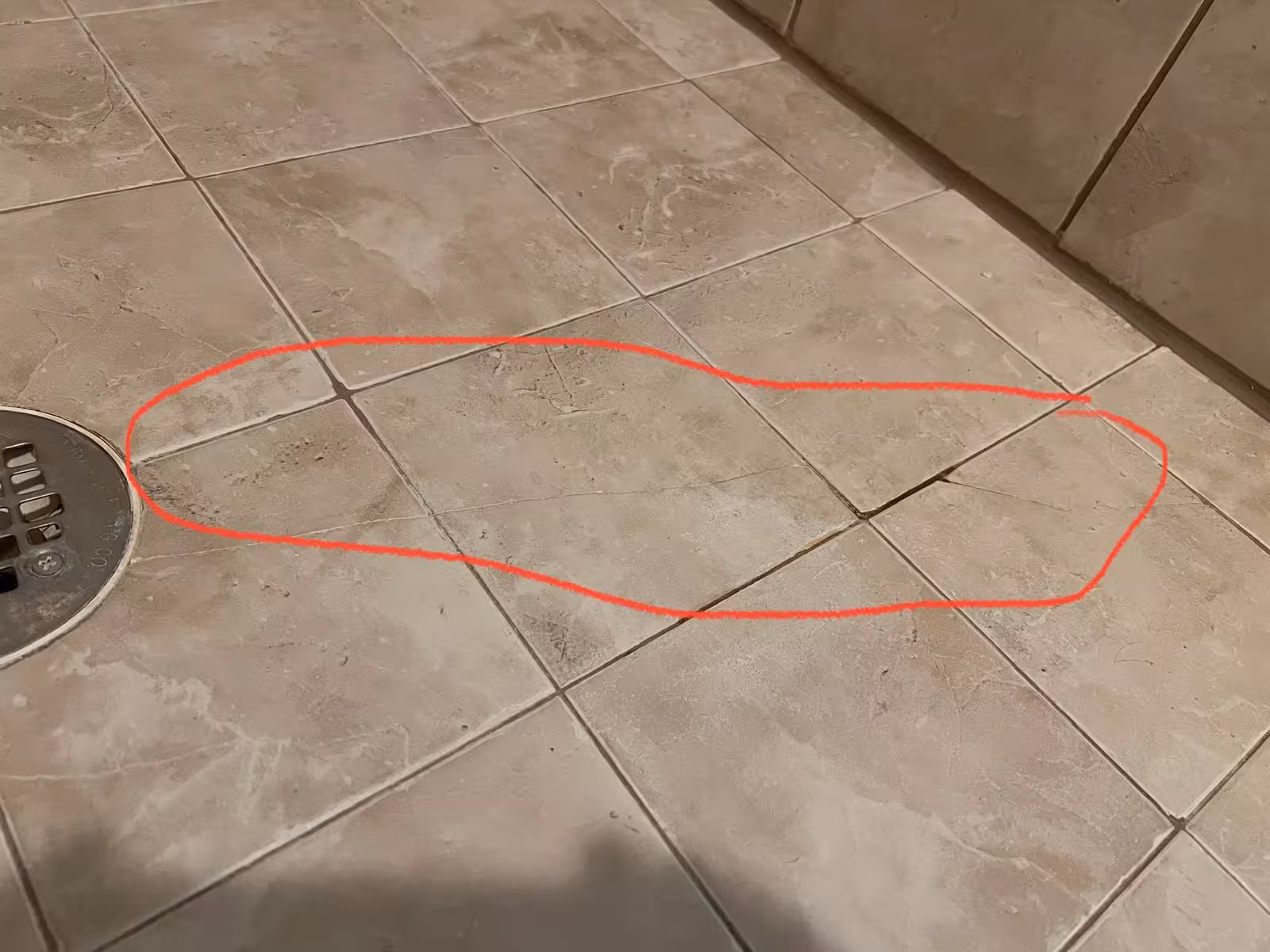 Shower pan water damage revealed during demolition with moisture intrusion areas marked Elizabeth CO