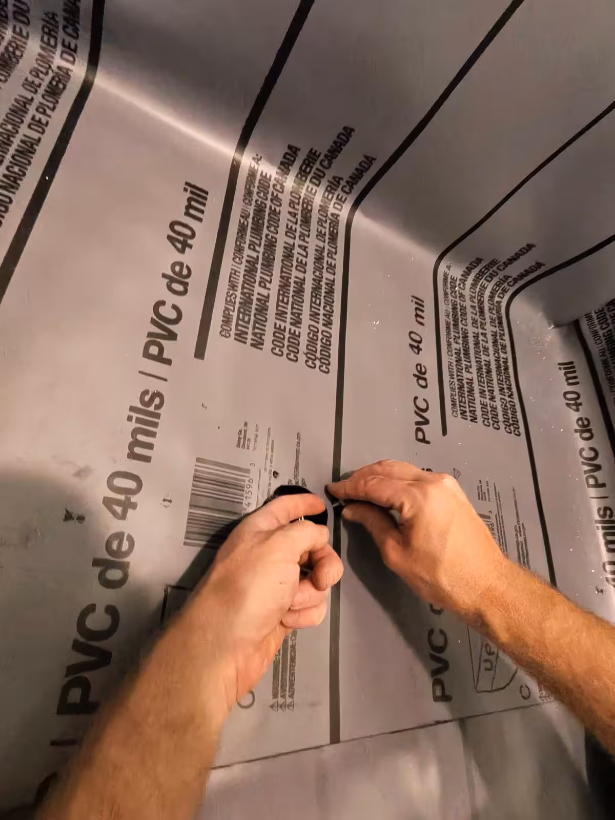 Marking PVC liner with marker for precise drain cutout Denver